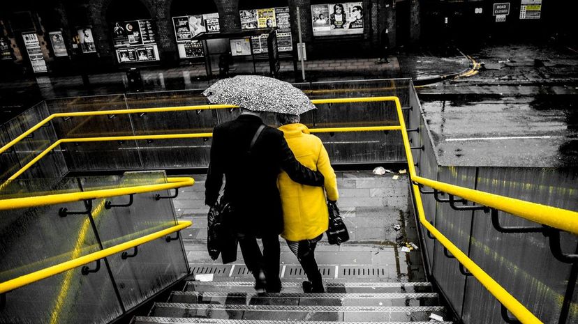 Couple Holding Umbrella