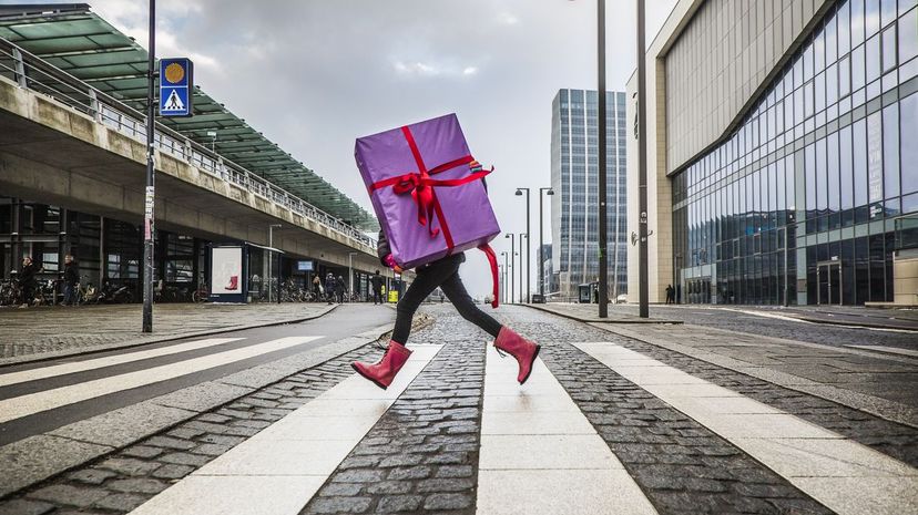 Q23-Young girl running with large gift on street