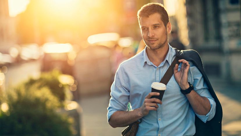 You're Stopping Traffic / handsome man sunset city with bag coffee jacket over shoulder