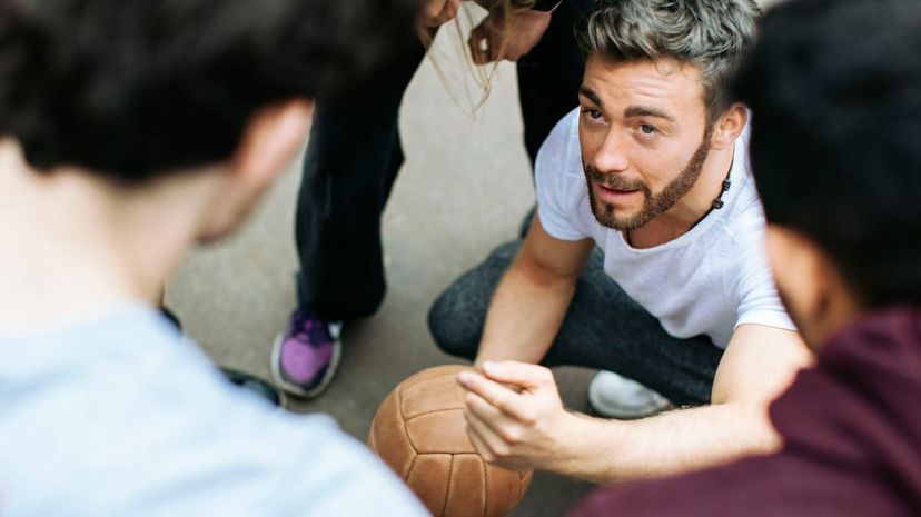 Team leader planning next steps with his soccer team