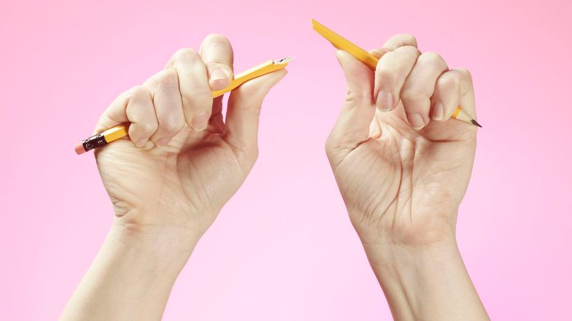 Hands holding broken pencil