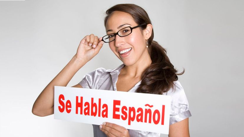 Women holds &quot;Se Habla Espanol&quot; sign