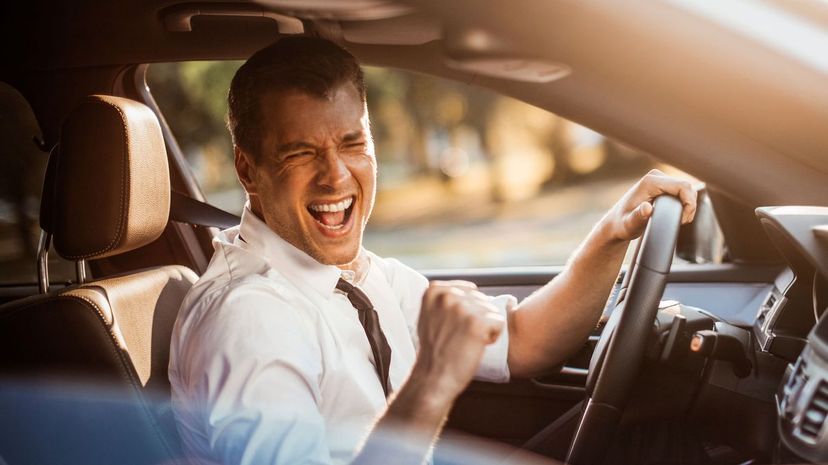 Excited man driving a car