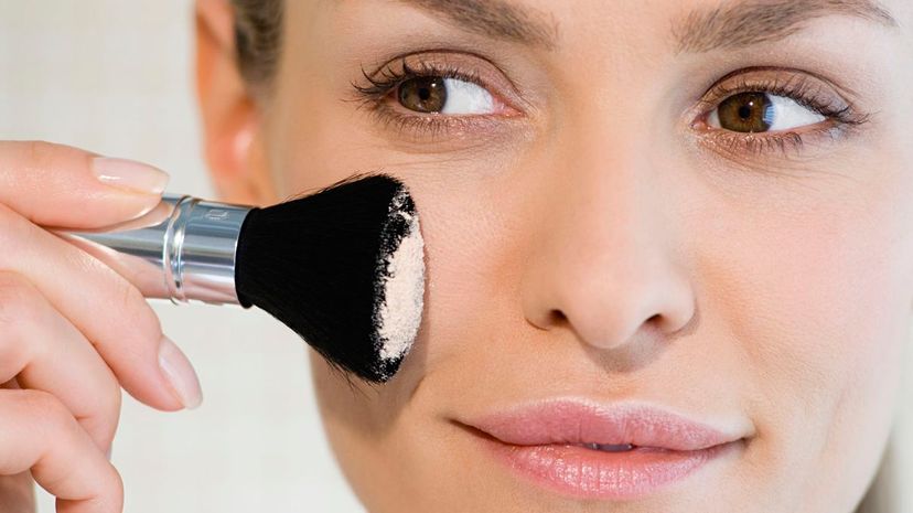 Woman applying face powder