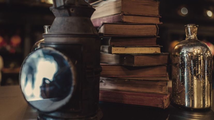 Old books and oil lamp