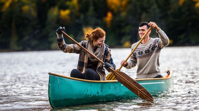 Couple enjoying a ride on a typical canoe in Canada