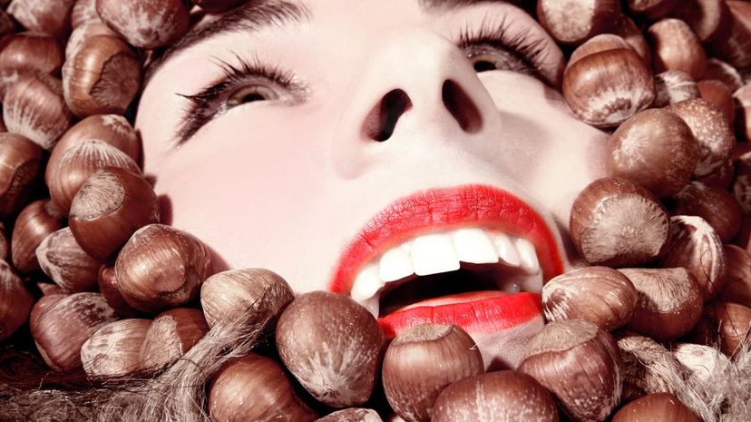 Woman's Face Surrounded by Hazelnuts