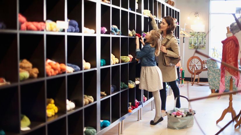 mom and daughter choosing yarn