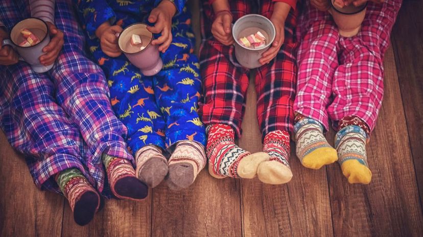 Cute Little Kids in Pyjamas and Christmas Socks Drinking Hot Chocolate