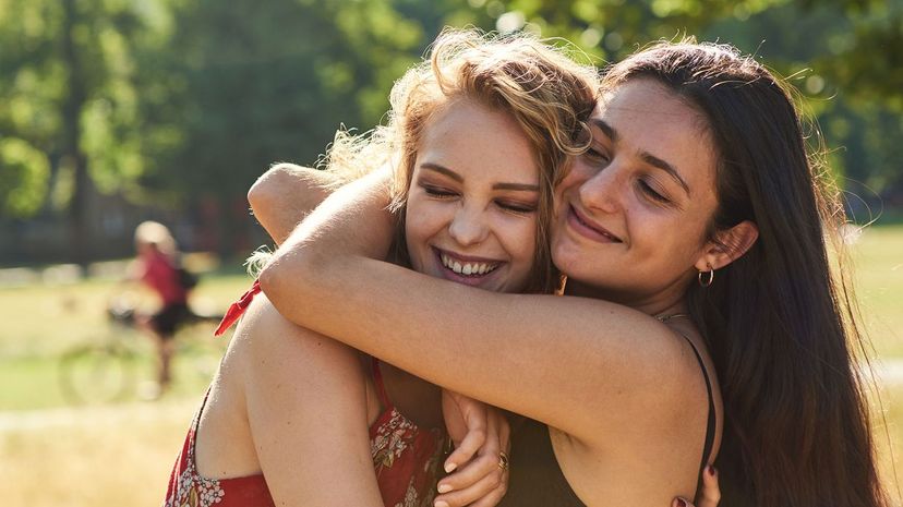 Two young women embracing each other lovingly