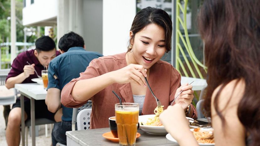 Group of friends eating lunch at an outdoor cafe