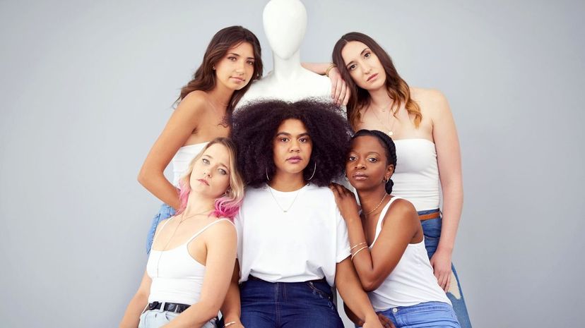 Women posing with a mannequin