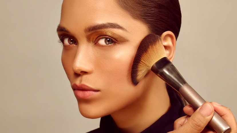 Woman using makeup brushes