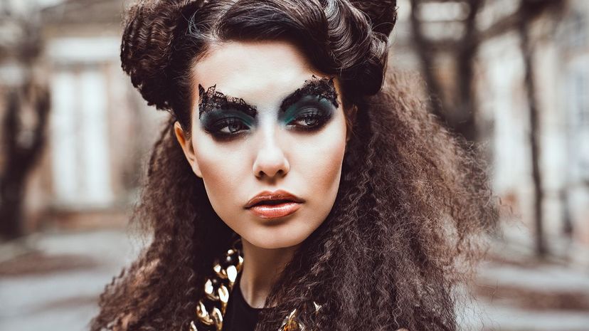 Portrait of young caucasian woman with creative makeup and hairstyle posing outdoor model