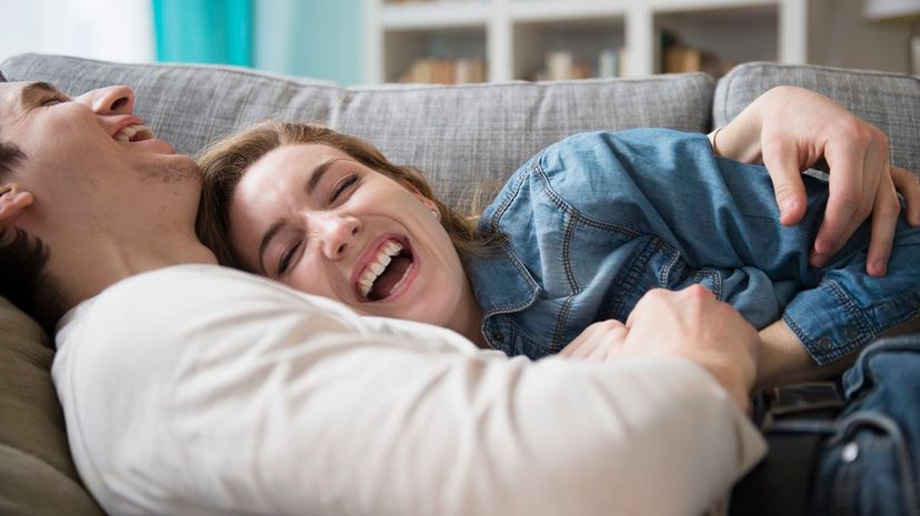 Couple laugh couch