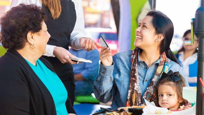 Customer paying for meal at Tex-Mex restaurant with credit card