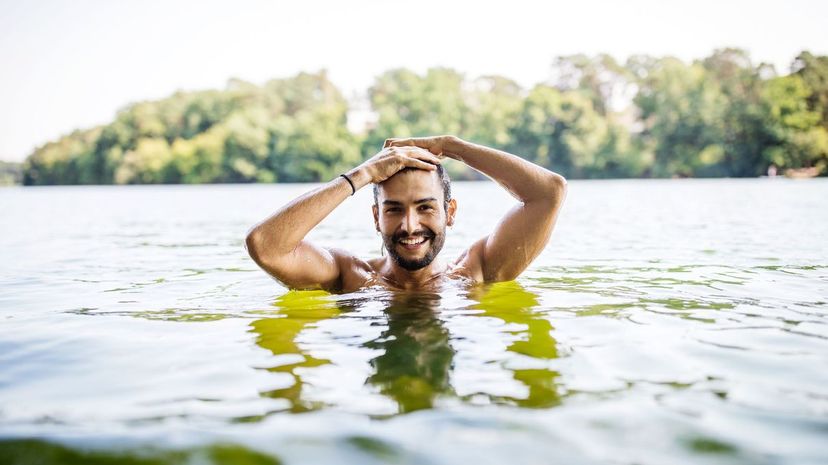 Young man swimming in lake