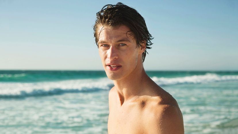 handsome man waves wet brown hair 