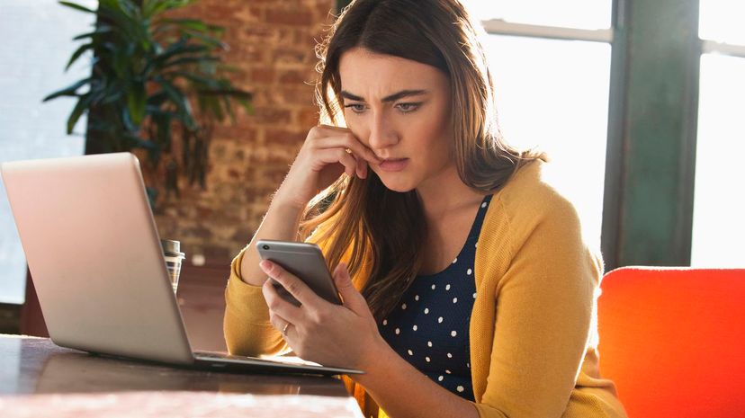 Stressed Caucasian businesswoman using cell phone