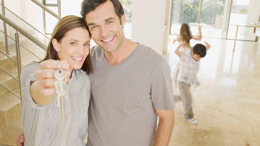 couple holding keys in new house