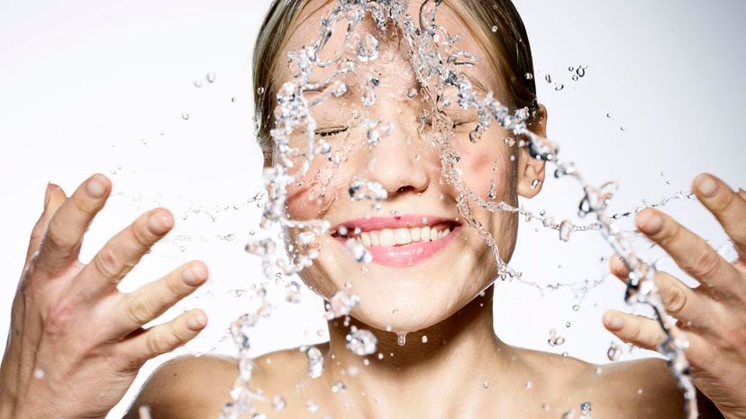 Woman splashing her face