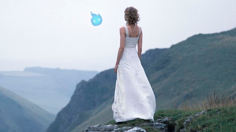 Woman on a mountain peak and will-o'-the-wisp