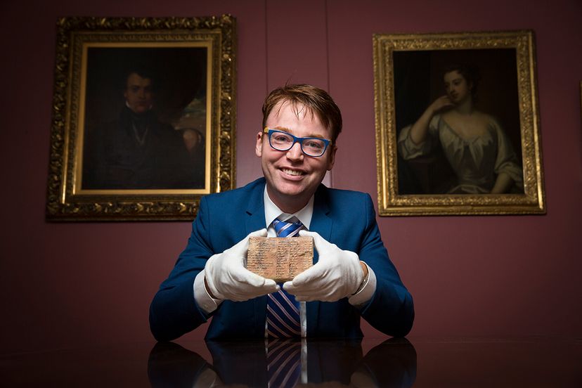 professor holding mesopotamian tablet