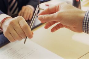 Hands exchanging pen. 