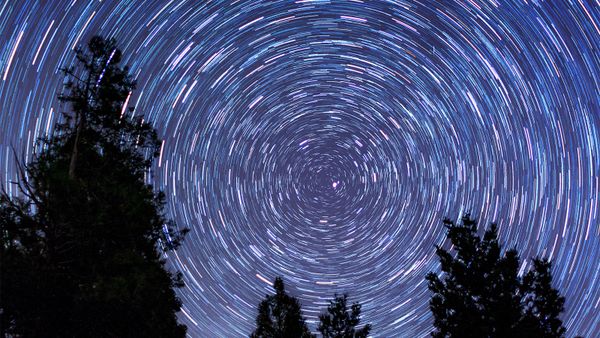 Night sky filled with star trails and the Milky Way.