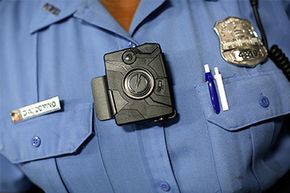 Washington D.C. Metropolitan Police Officer Debra Domino models a body camera that officers can attach to their uniforms on Sept. 24, 2014.