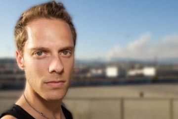 man in front of smoke stack