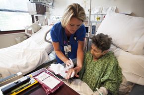 A nurse uses chlorhexidine gluconate bath wipes on an elderly patient at a Florida hospital. Some hospitals have found the wipes to be handy in protecting ICU patients from MRSA infections.