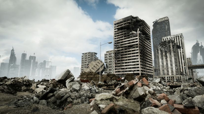 Digitally generated post-apocalyptic scene depicting a desolate urban landscape with tall buildings in ruins and mostly cloudy sky.