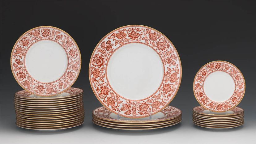 Porcelain dishes displaying a Red Damask pattern.