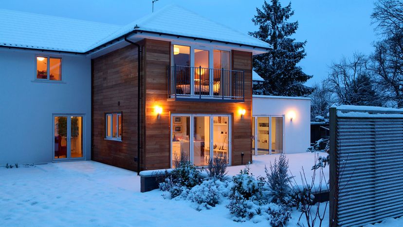 house in winter with porch lights