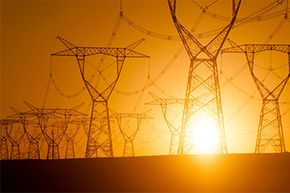 A network of electricity pylons in central Xinjiang, China, is silhouetted against the setting sun. See images of nuclear power.