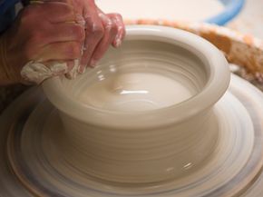 Potter at work at his pottery wheel 