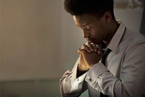 Person praying with eyes closed
