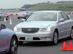 A Toyota Majesty equipped with safety technology, driven by Toyota Motor Corp. President Katsuaki Watanabe, stops near another car to avoid a collision during a test run.