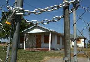 An abandoned home sits beyond a locked gate in Stockton, Calif. According to RealtyTrac Inc., Stockton had the highest foreclosure rate of large metropolitan areas in the third quarter of 2007, with one of every 31 homes in foreclosure.