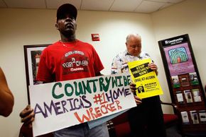 Marcus West and Larry Heard take part in a protest by ACORN at Countrywide home loans center in October 2007. The nonprofit organization accused Countrywide of predatory lending practices.