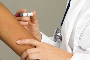 Woman doctor giving patient injection