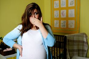 Pregnant woman covering nose