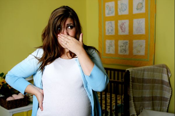 Pregnant woman covering nose