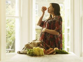 pregnant woman smelling food