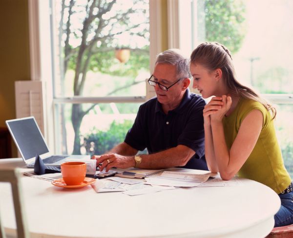 Woman and father perusing financial information