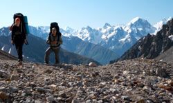 Person hiking outdoors with backpack up mountain.