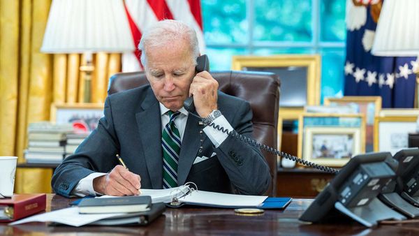 Businessman indoors speaking on telephone.