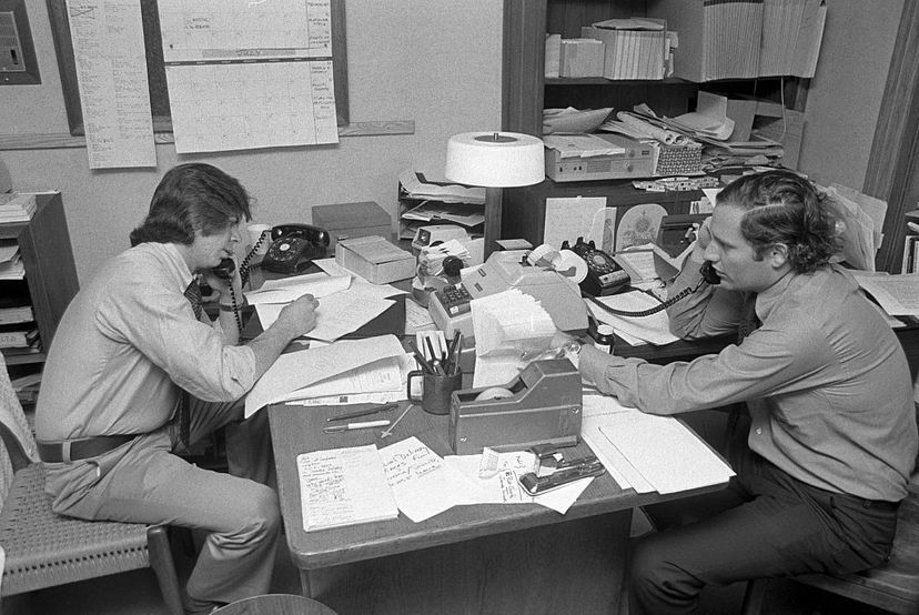 Carl Bernstein (L) and Bob Woodward (R) make phone calls before a radio show taping on June 17, 1974, in New York City. Both reporters were lauded for their uncovering of what came to be called the Watergate scandal. Waring Abbott/Getty Images