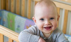 Baby smiling in crib